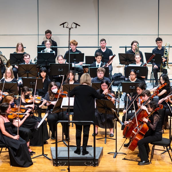 Photo by Logan de Raaspide Ross 2023 orchestra performing with conductor's back to audience