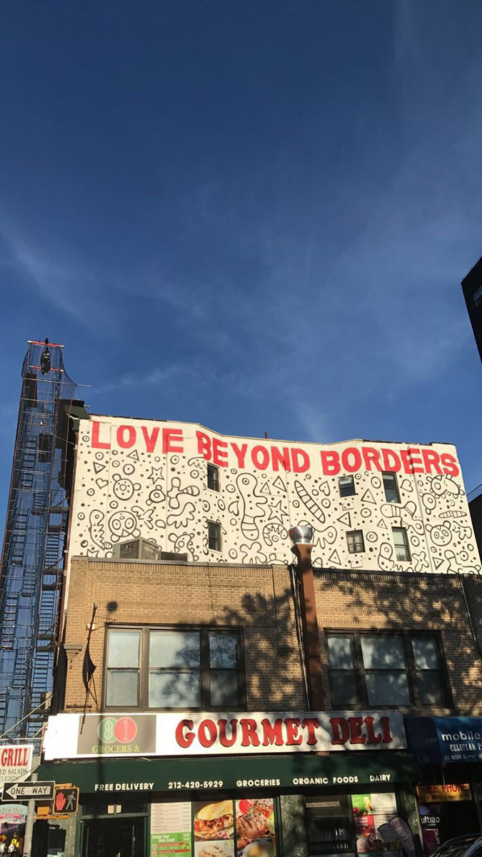 Love Beyond Borders sign atop a business