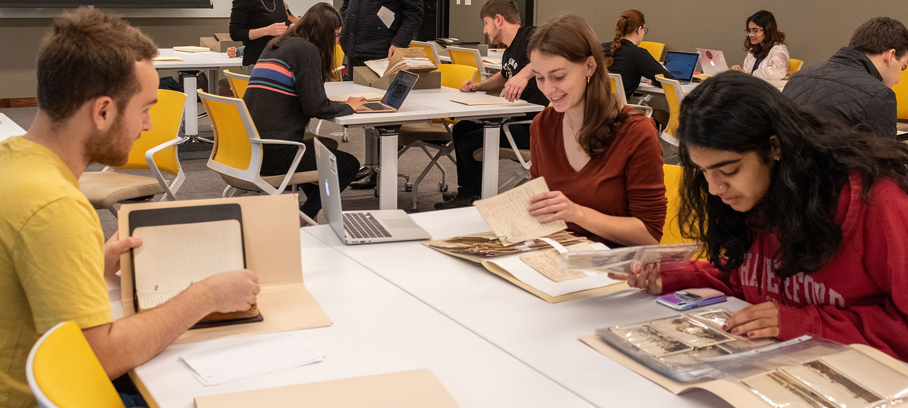 Students pouring over materials in the library