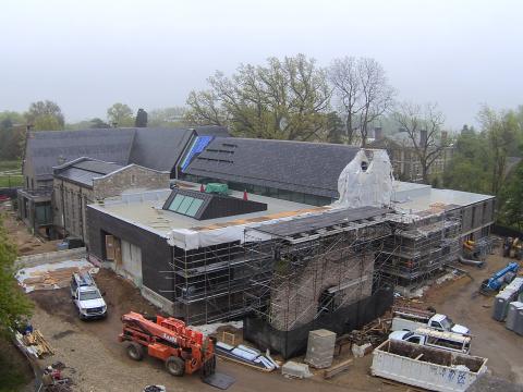 Exterior of the library under construction on a sunny day.