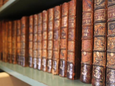 a shelf of red-brown books, all matching