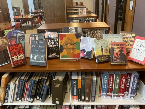 Photo of a display of books on top of a half-height bookcase in Lutnick Library.