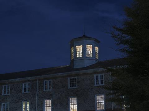 Founders Hall at night with the cupola lit up