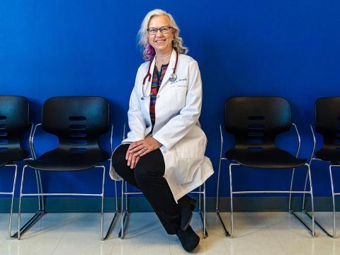 Dr. Yngvild Olden seated in her white lab coat