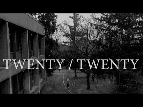 A black-and-white photo of campus in the snow, as seen from a second-story window with the words "Twenty/Twenty" written over them.