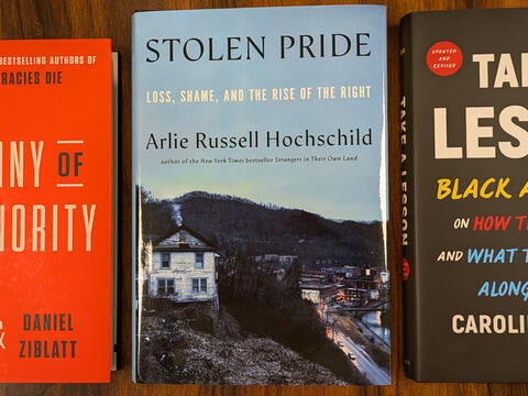 Three book covers: Tyranny of the Minority, with black and white text on a red background; Stolen Pride, featuring a photo of a run down house in winter; and Take a Lesson, featuring white, yellow, red, and blue text on a black background.