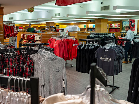 A wide view shows new merchandise, including tshirts and sweatshirts, in the College's renovated bookstore. 