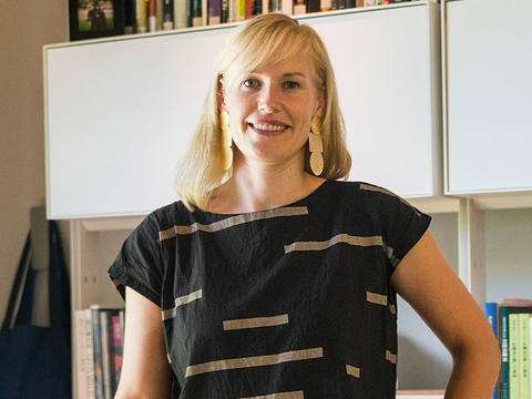 Professor Erin Schoneveld wears a black shirt in a portrait taken in her office on Haverford's campus. 