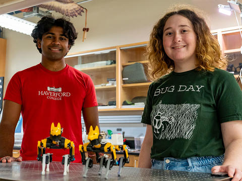 Deep and Willow stand in their lab in the KINSC. They are pictured with their robot dogs, Anubis and Horus.