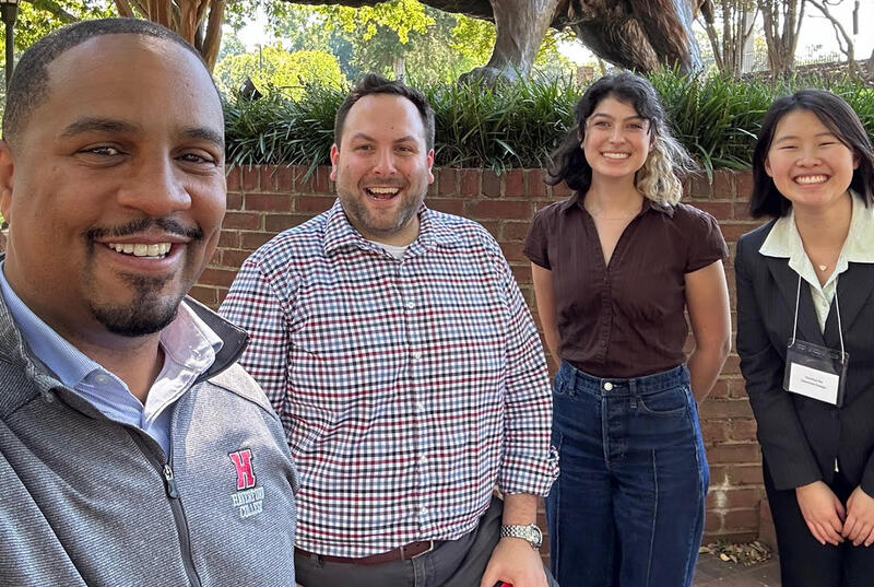 Four people are pictured in a selfie taken by Dean of the College John McKnight.