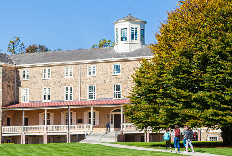 Founders Green on a sunny day with a handful of students walking past