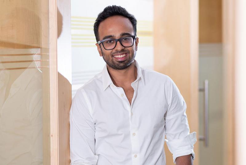 Shreyas Shibulal wears glasses and a button-down shirt and smiles for the camera