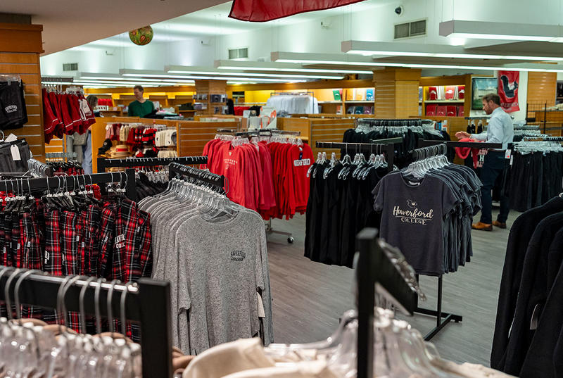 A wide view shows new merchandise, including tshirts and sweatshirts, in the College's renovated bookstore. 