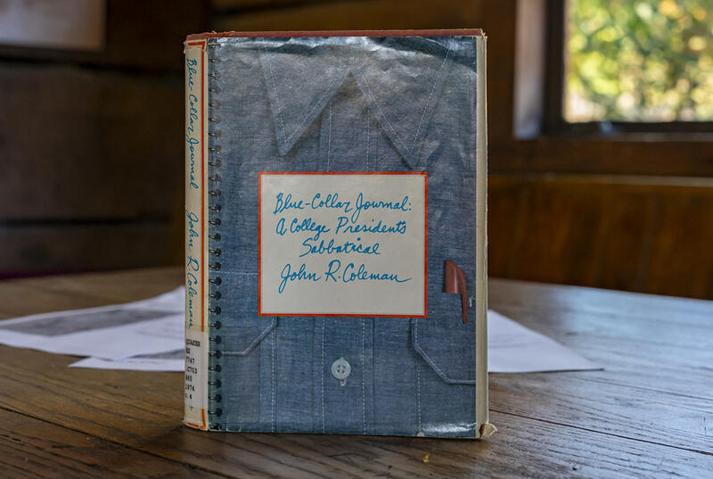 A copy of Jack Coleman's book, Blue Collar Journal, sits upright on a wooden table in Haverford's Skate House.