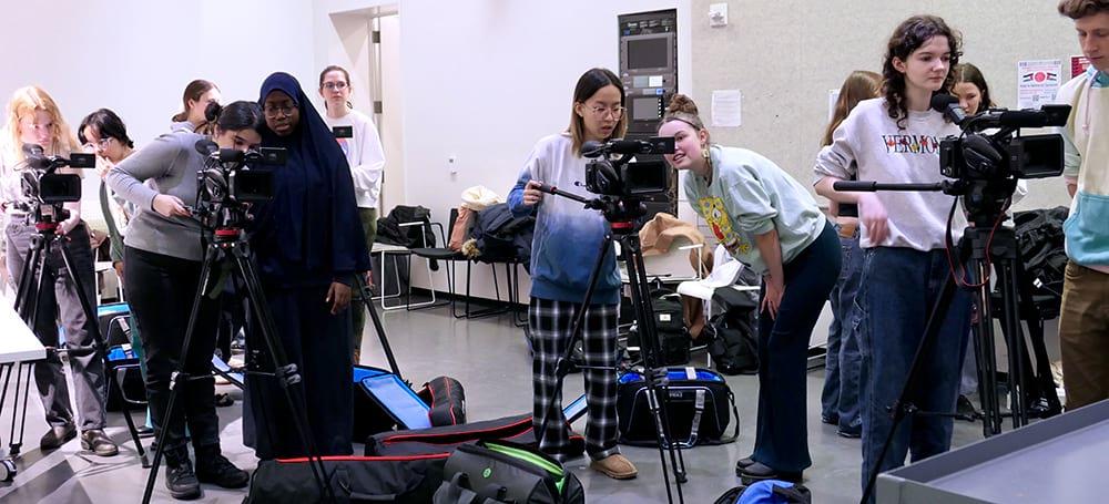 Students in John Muse’s Visual Studies course Foundations of Film Production learning to use camera equipment.