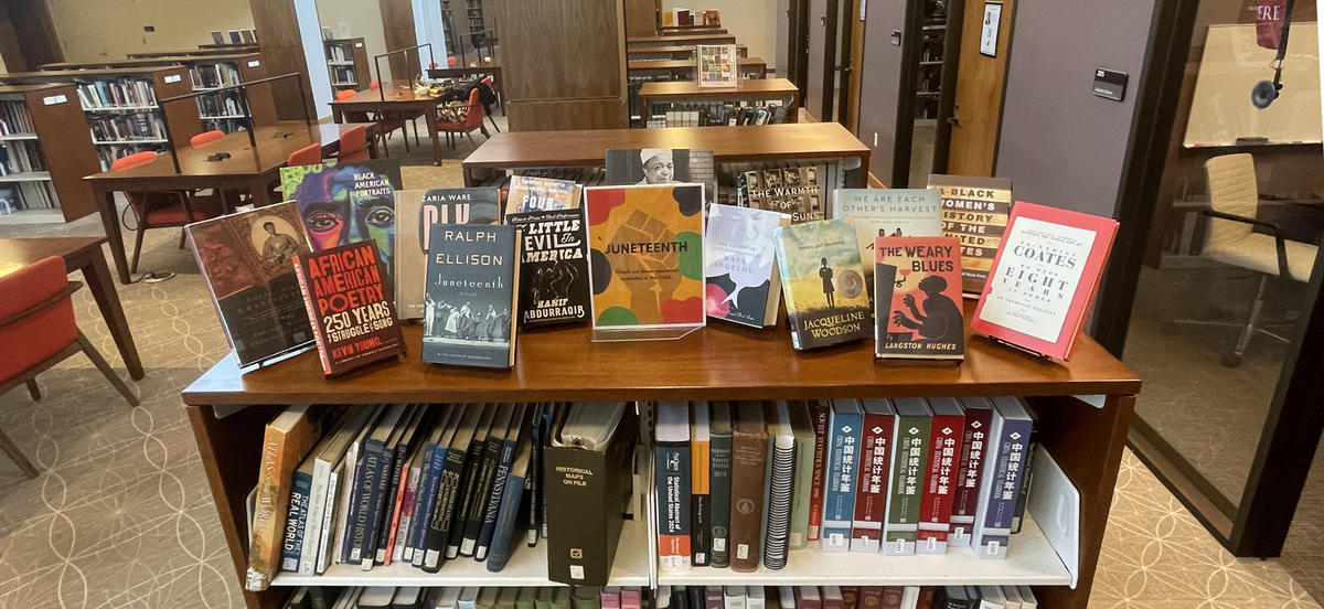 Photo of a display of books on top of a half-height bookcase in Lutnick Library.