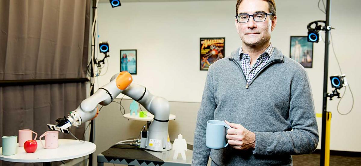 Eric Krotkov with a robotic arm