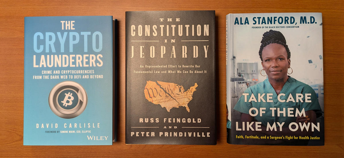 Three book covers: The Crypto Launderers, featuring a bitcoin symbol; The Constitution in Jeopardy, featuring the Constitution in the shape of the US, ripping in half; and Take Care of Them Like My Own, featuring a Black woman in green scrubs.