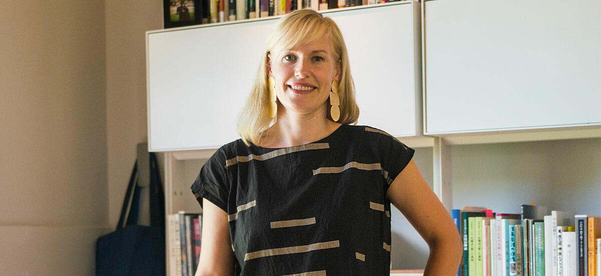 Professor Erin Schoneveld wears a black shirt in a portrait taken in her office on Haverford's campus. 