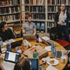 Students sit around a crowded table surrounded by bookshelves in Haverford's Strawbridge Observatory.